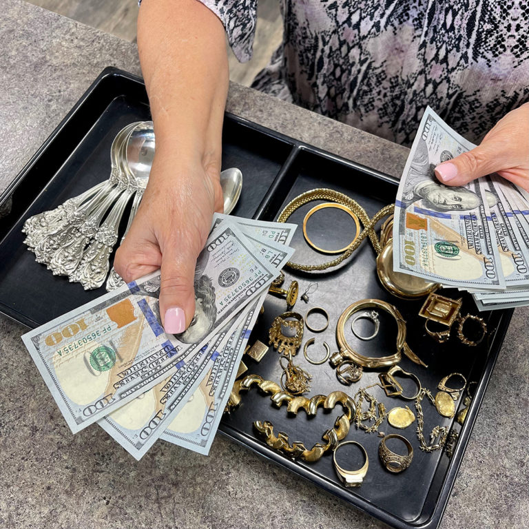 A woman exchanging cash for jewelry