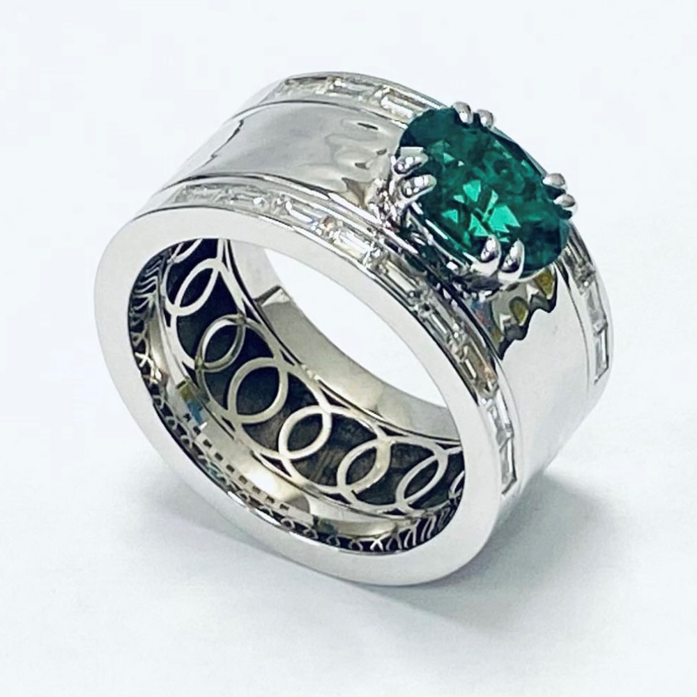 Yellow Gold Ring with Wide Band. Oval Green Center Gemstone and a row of baguette diamonds on each edge