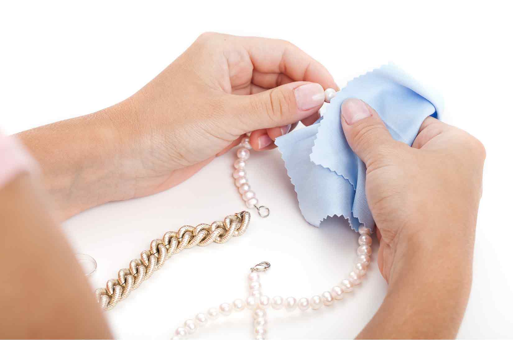 pearl and gold chain cleaning with light blue cloth