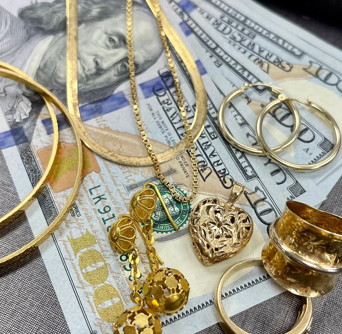 Gold jewelry and money laid out for display